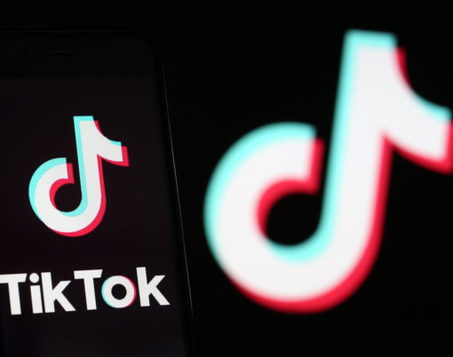 PARIS, FRANCE - SEPTEMBER 15: In this photo illustration the logo of Chinese media app for creating and sharing short videos TikTok, also known as Douyin is displayed on the screen of a smartphone in front of a TV screen displaying the TikTok logo on September 15, 2020 in Paris, France. US software and hardware manufacturer Oracle Corporation confirmed Monday (September 14th) that it had made a proposal to take over the US operations of the Chinese video-sharing application TikTok, as the US government had announced earlier. The takeover of the American branch of the Chinese social network by an American company is at the heart of a battle between Washington and Beijing. (Photo by Chesnot/Getty Images)