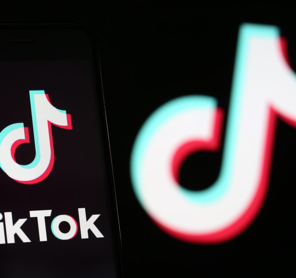 PARIS, FRANCE - SEPTEMBER 15: In this photo illustration the logo of Chinese media app for creating and sharing short videos TikTok, also known as Douyin is displayed on the screen of a smartphone in front of a TV screen displaying the TikTok logo on September 15, 2020 in Paris, France. US software and hardware manufacturer Oracle Corporation confirmed Monday (September 14th) that it had made a proposal to take over the US operations of the Chinese video-sharing application TikTok, as the US government had announced earlier. The takeover of the American branch of the Chinese social network by an American company is at the heart of a battle between Washington and Beijing. (Photo by Chesnot/Getty Images)